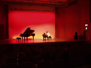 Hisae playing a piano.