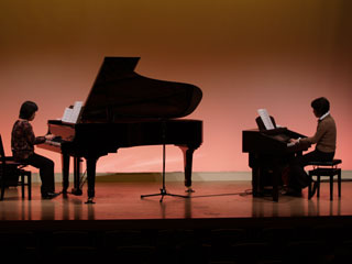 Hisae playing a piano.